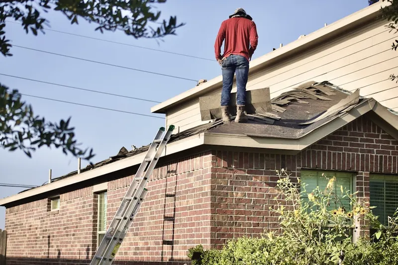 Professional roofer working on a residential roof in Campground Landing